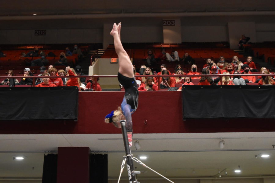Eighth grader Chloe Myer during the handstand before giants on the bars at state.