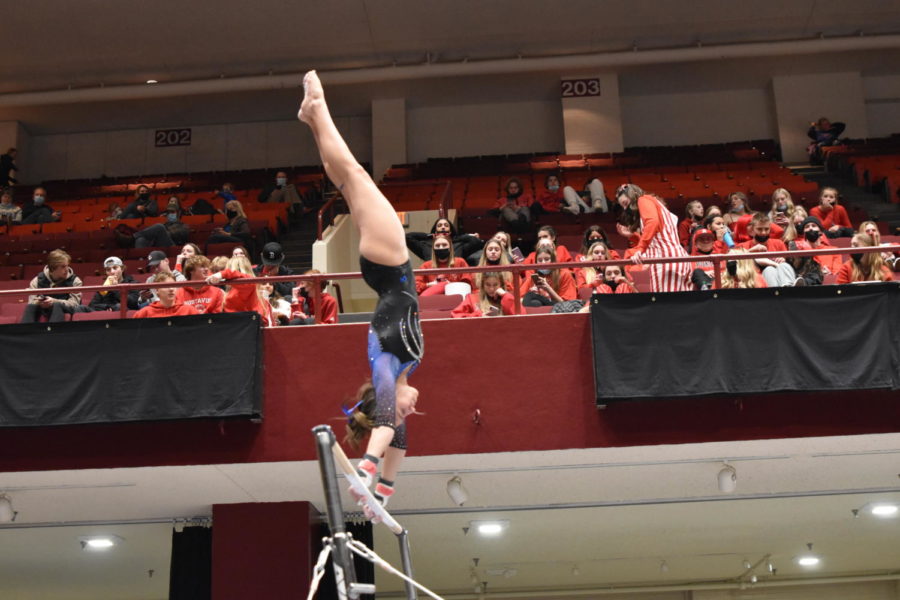 Freshman Jozie Johnson during the giants in her bar routine at the team competition.