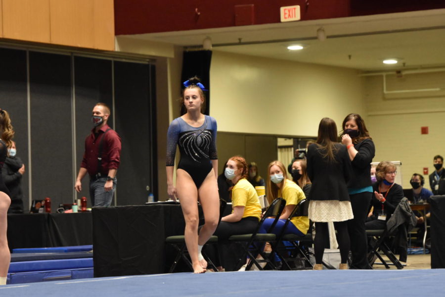 Junior Kaitlyn Cobban moments before starting her floor routine during the team competition.