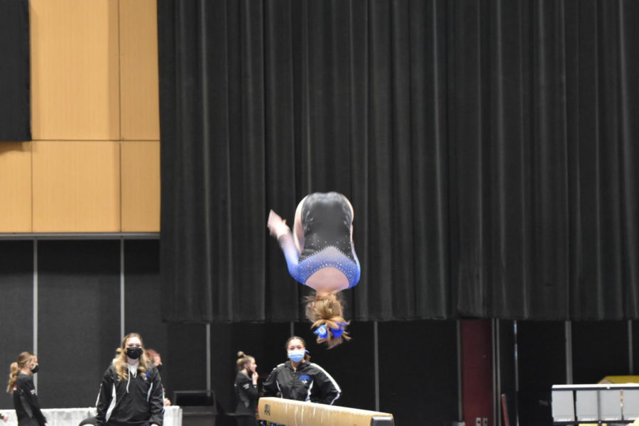Freshman Averie Roush on the beam during the team competition.