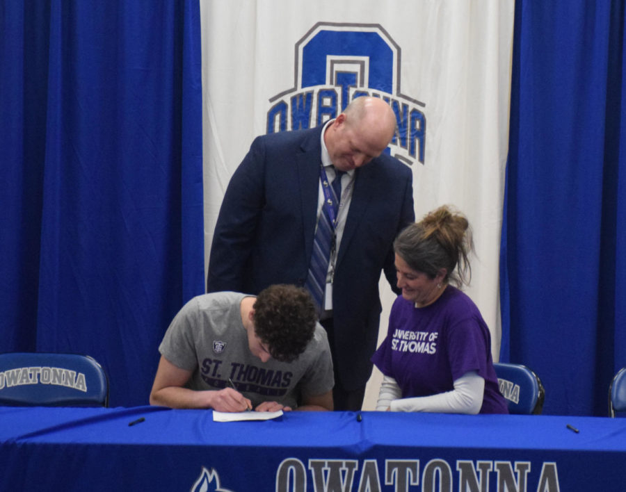 Grant Achterkirch signs his letter of intent to play football at St. Thomas University.