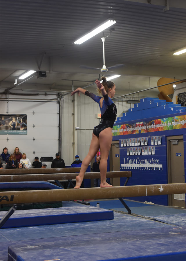 Gymnast Dylann Norrid after finishing a full toe turn on the balance beam.