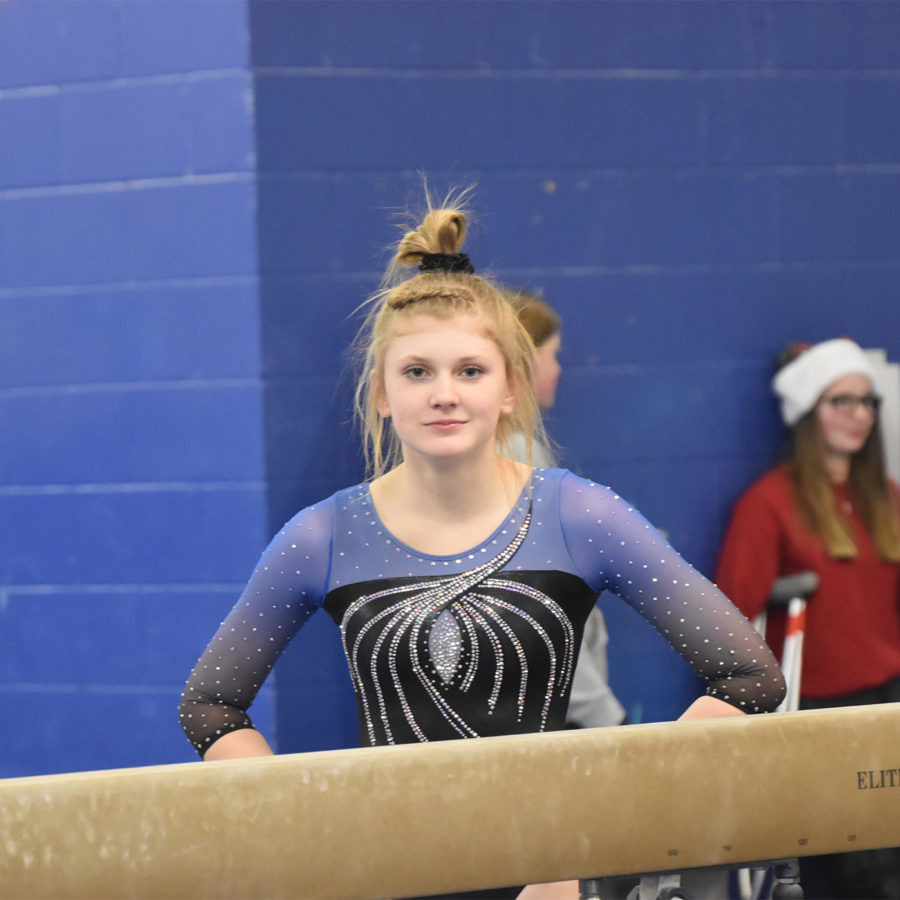 Junior Jayna Martin waiting to compete on the balance beam.