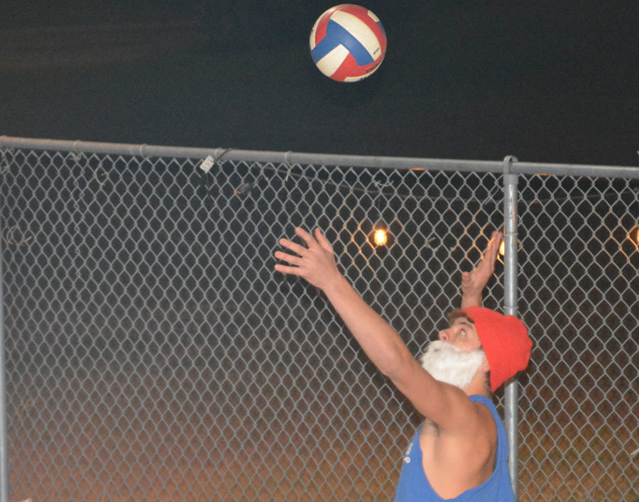 Jack Simmons serving in the championship game in the sand volleyball tournament.