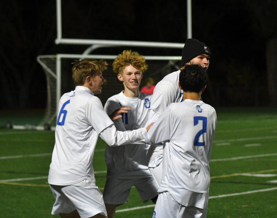 GOAL. Senior Benny Bangs jumps for joy with his teammates after his goal in the first half.