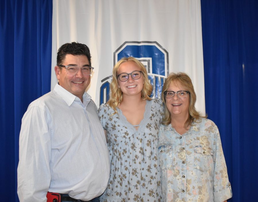 Senior Emily Schmidt with her family after the NHS induction ceremony.