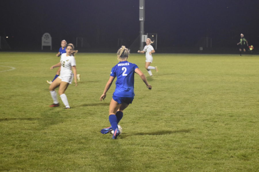 Sophomore Kennedy Schammel with ball at feet looking to pass to Sarah Snitker.