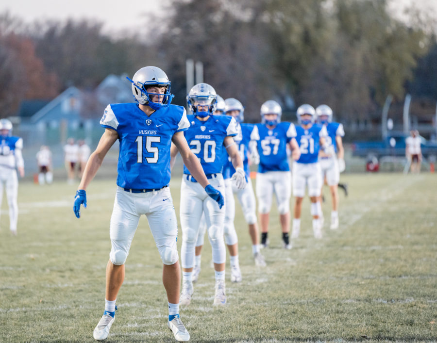 PRE-GAME RITUAL. Varsity football team warms up with the Owatonna pre-game ritual.