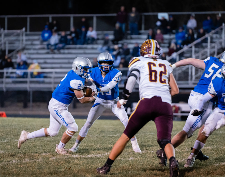 GREMSWORTH. Junior Jacob Ginskey handing the ball off to Senior Conner Grems.