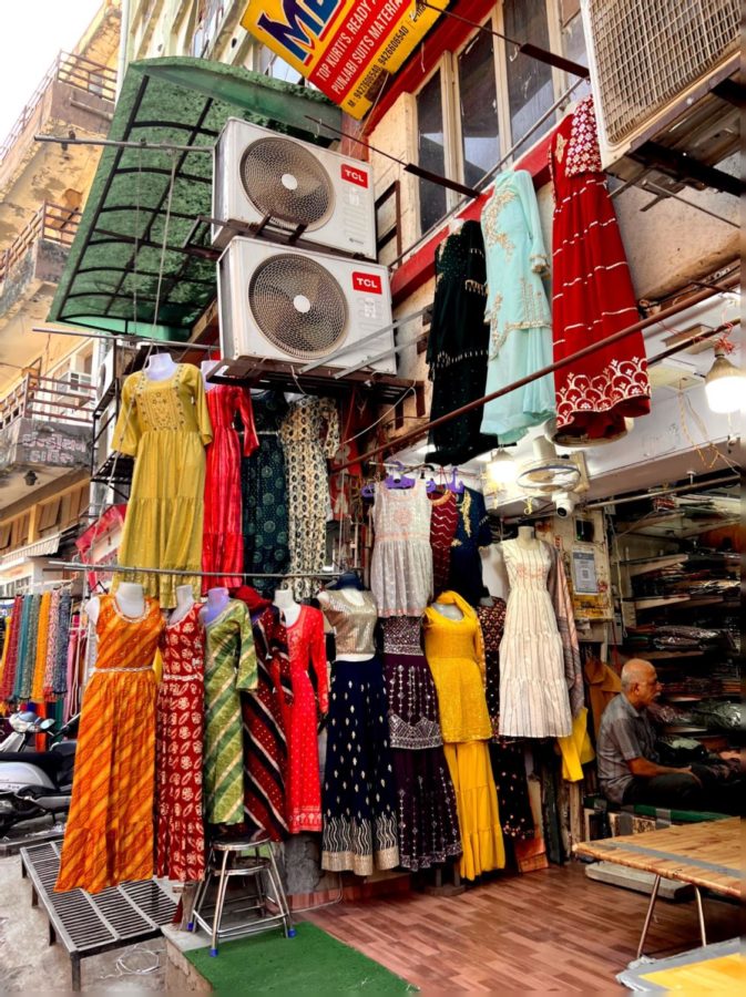 Multiple dukans (shops) display traditional clothing to advertise their designs. 
