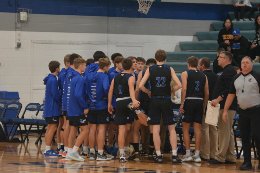 Boys Basketball team huddles up before the start of their game against the Austin Packers.