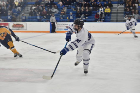 Sophomore defensemen Blake Davidson passes the puck up the ice.