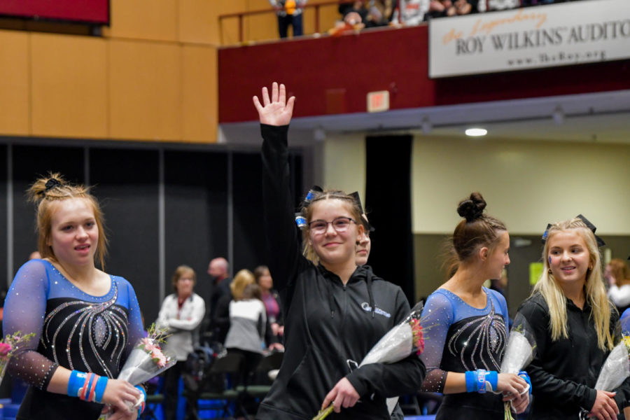 Eighth grader Johanna Speilman waving at the crowd during the parade of champions at the state tournament. 
