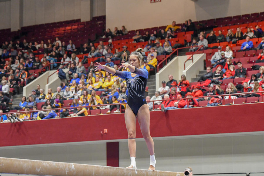 Junior Emma Johnson on the beam before sticking her routine and ending with a score of 8.500.