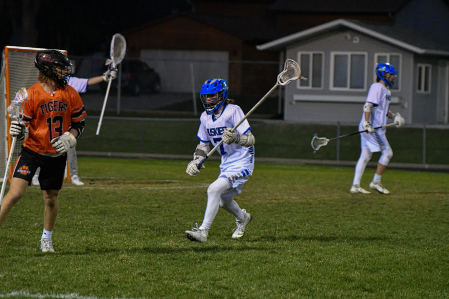 Sophomore Lane Karsten ready to defend the Huskies goal against the Tigers.