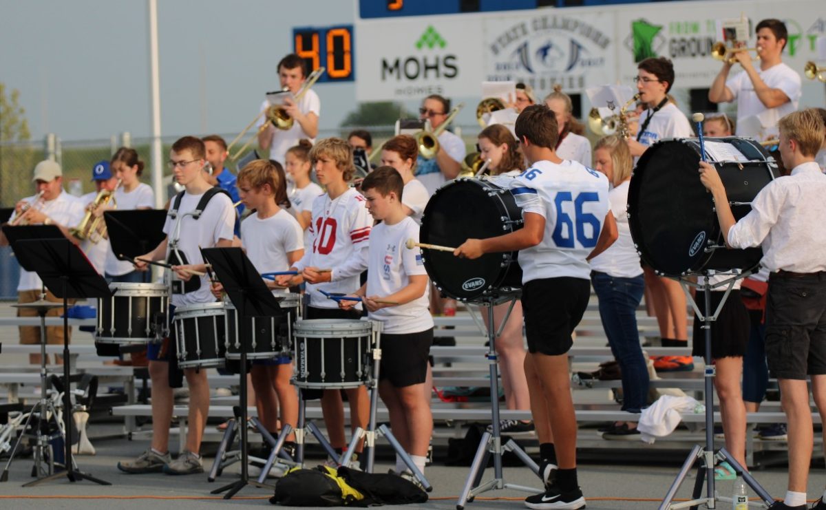Community members gathered together for the first game of the seasons pep band