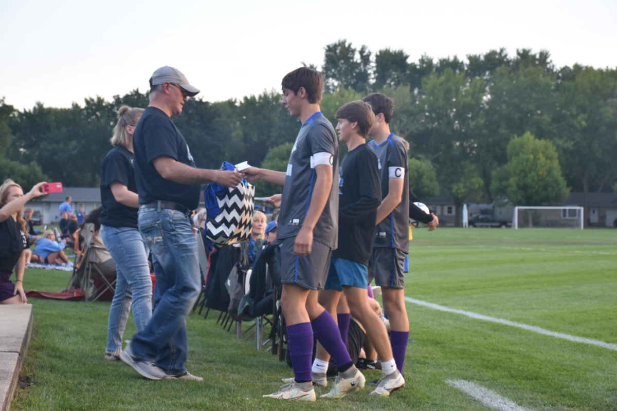 Boys+soccer+captains+hand+Dylan+Lauwers+parents+a+gift+in+memory.