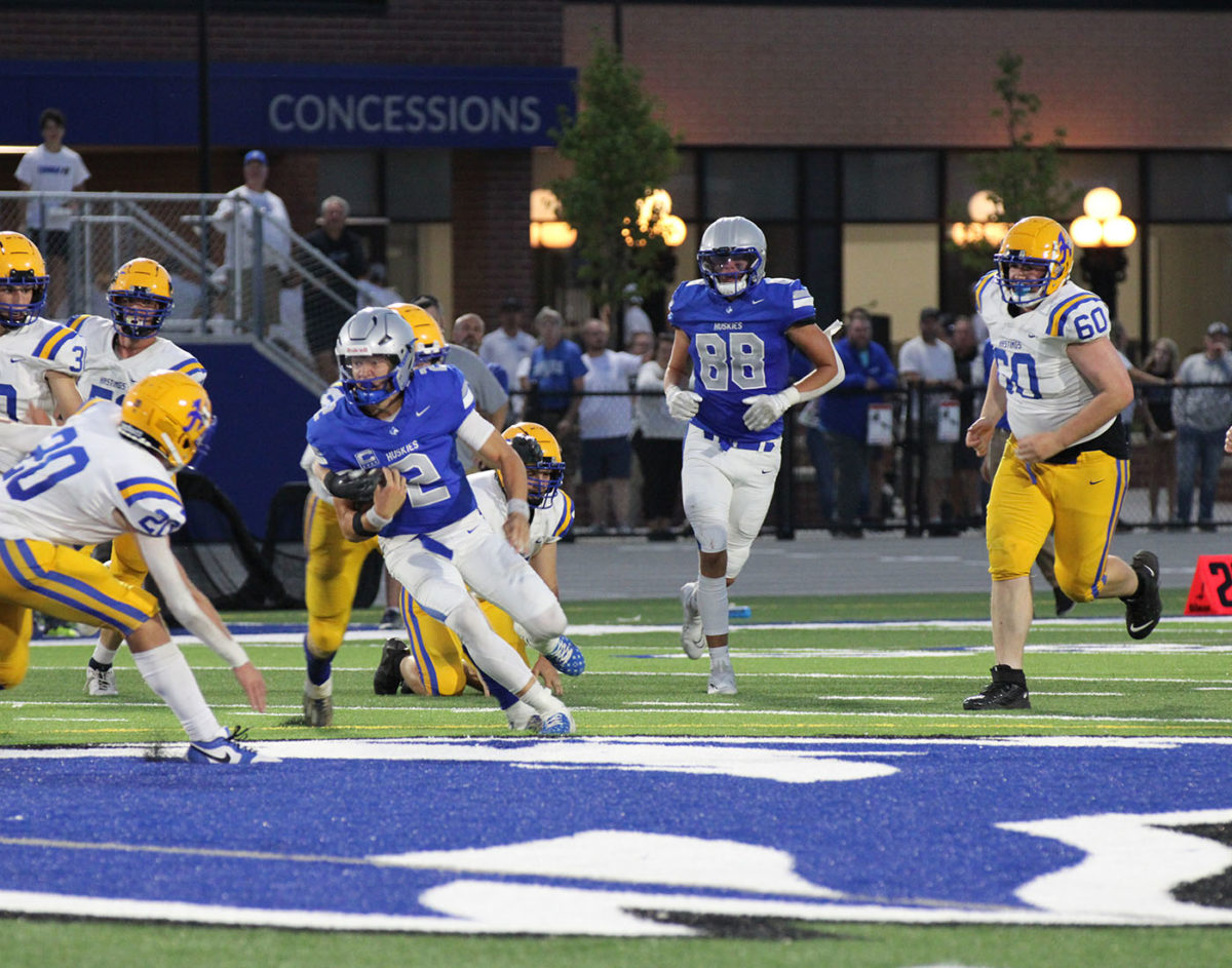 Senior quarterback Jacob Ginskey drives into the pocket for a positive gain of yardage.