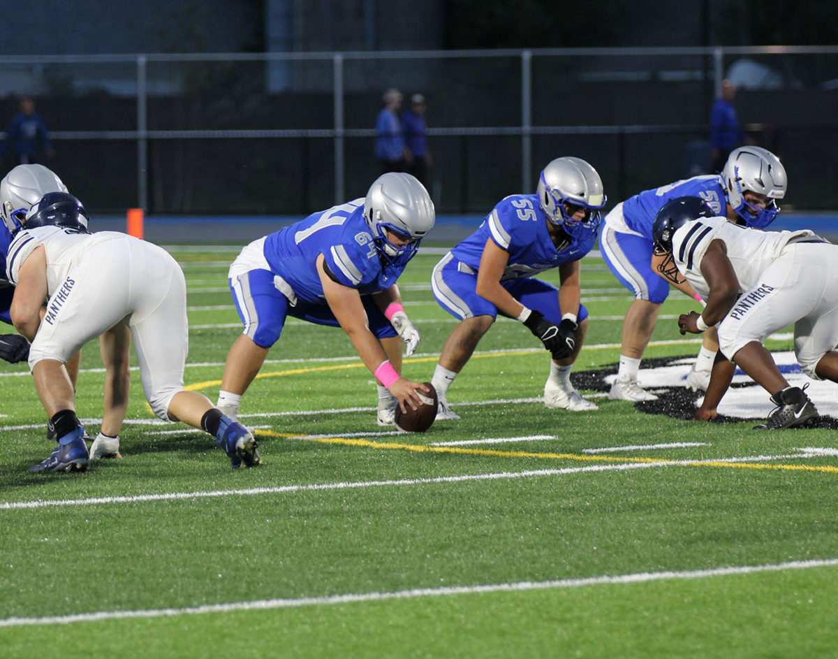 Junior center Jack Meneguzzo is getting ready to snap the ball.