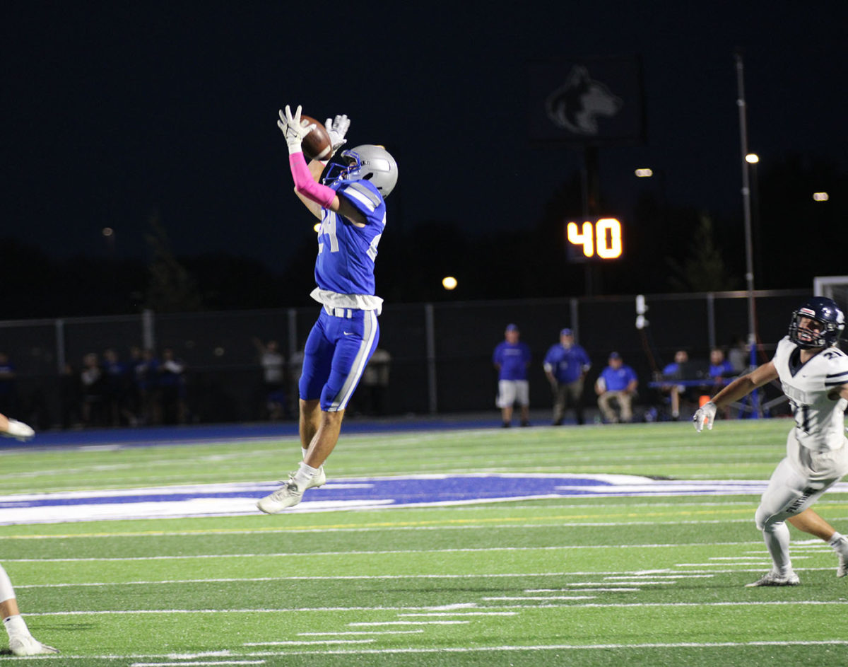 Senior Rielly Kleeberger leaps in the air to catch a pick-six for the Huskies.