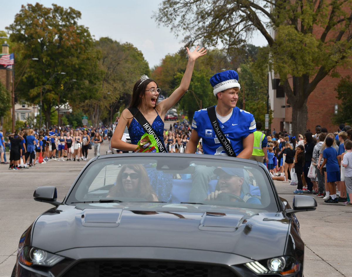 Homecoming King Jacob Ginskey and Queen Anna Cox going through the parade.