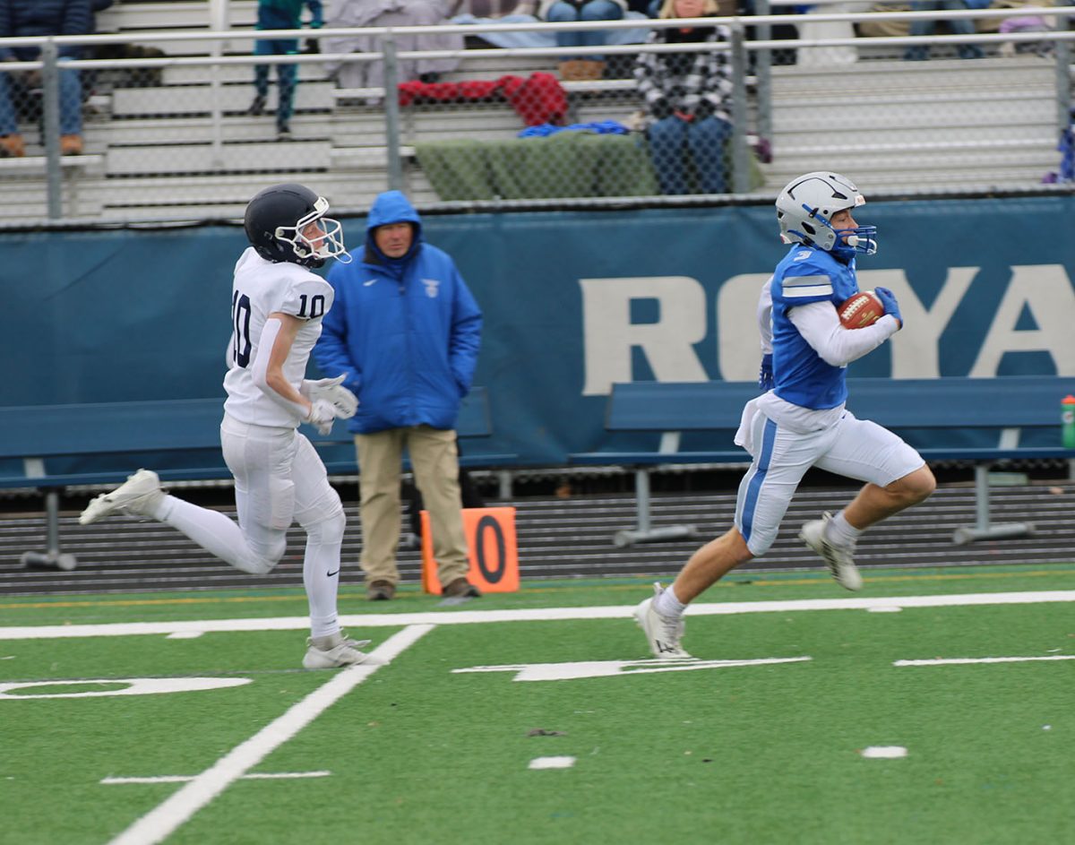 Junior Nolan Ginskey runs for the first touch down of the game.