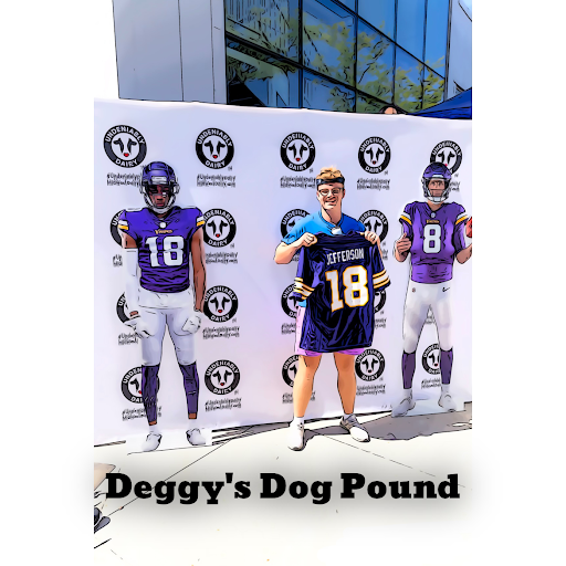 Photo of Jackson DeGrood at a Vikings training camp standing next two players cutouts.