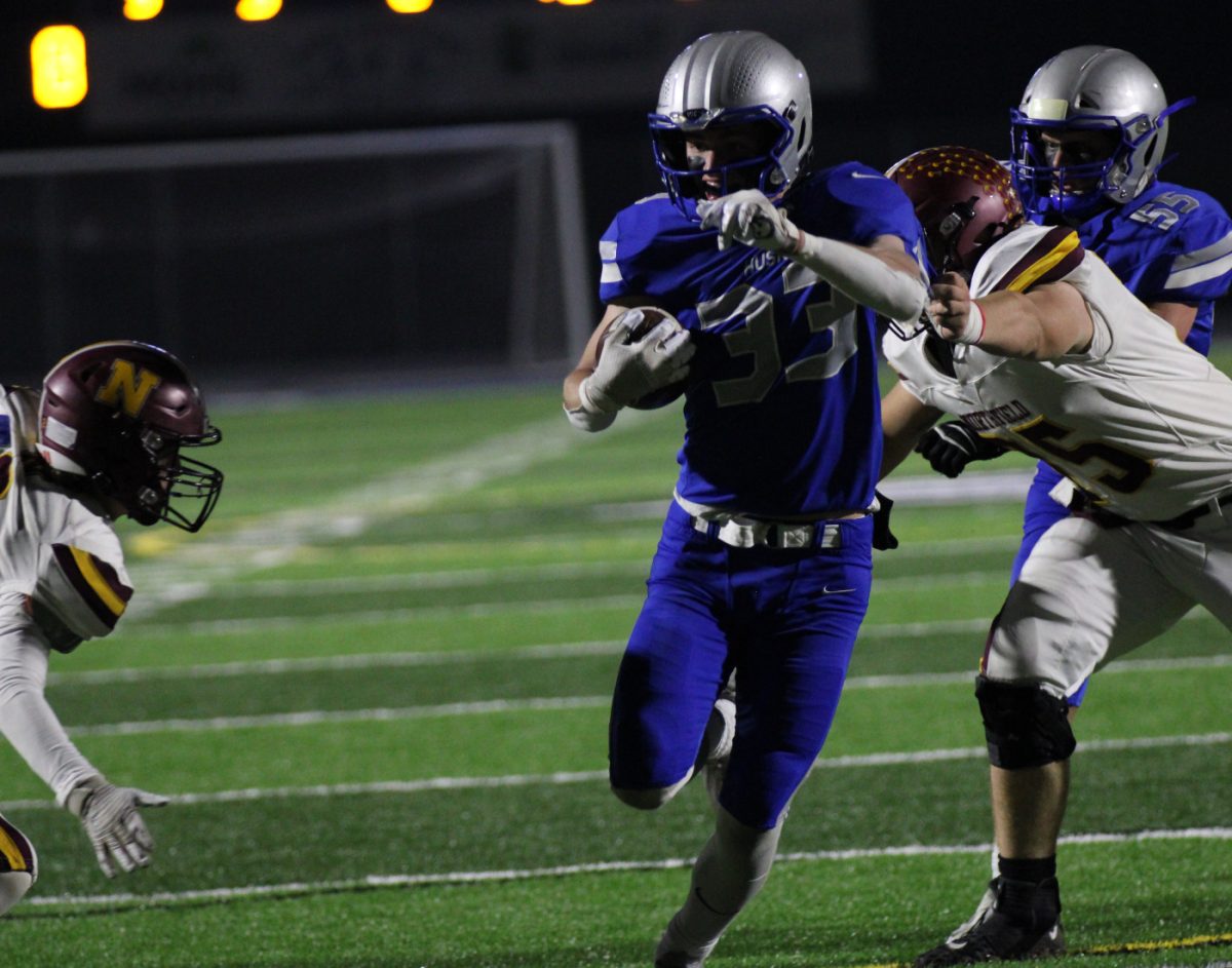 Senior running back Brennan Sletten evades defenders and drives for a Huskie touchdown.