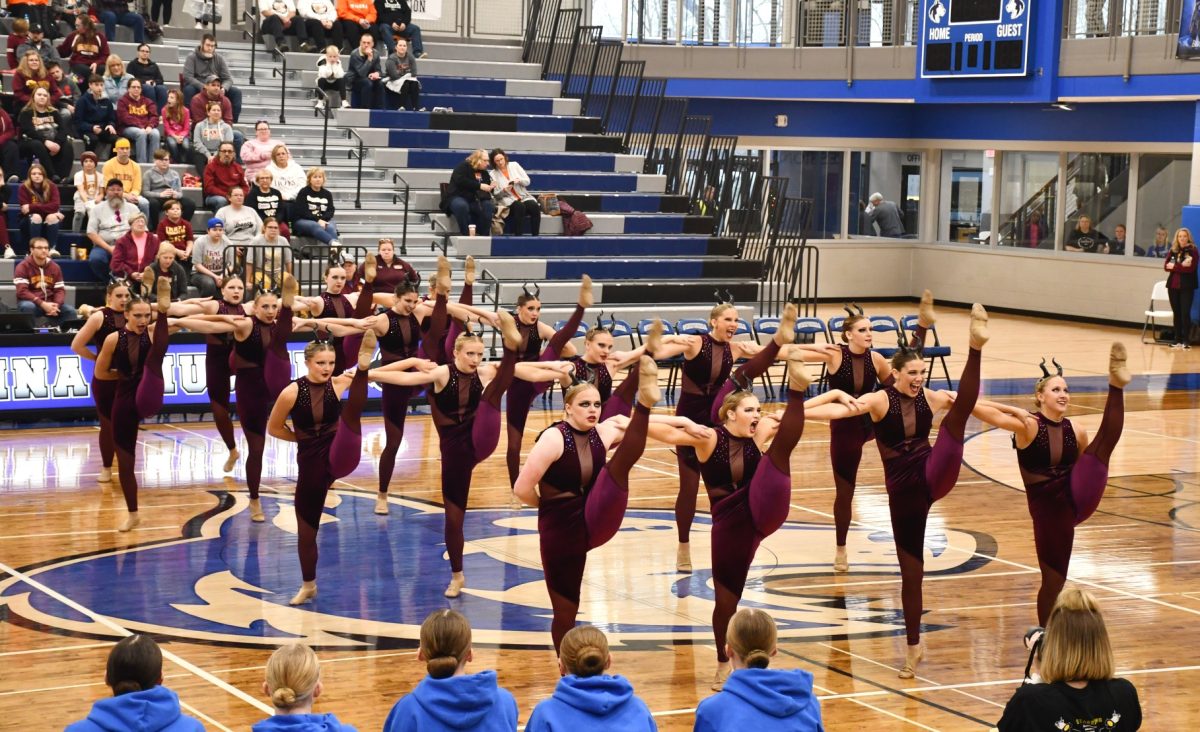 Varsity kick competes their dance to the song Once Upon a Dream. 