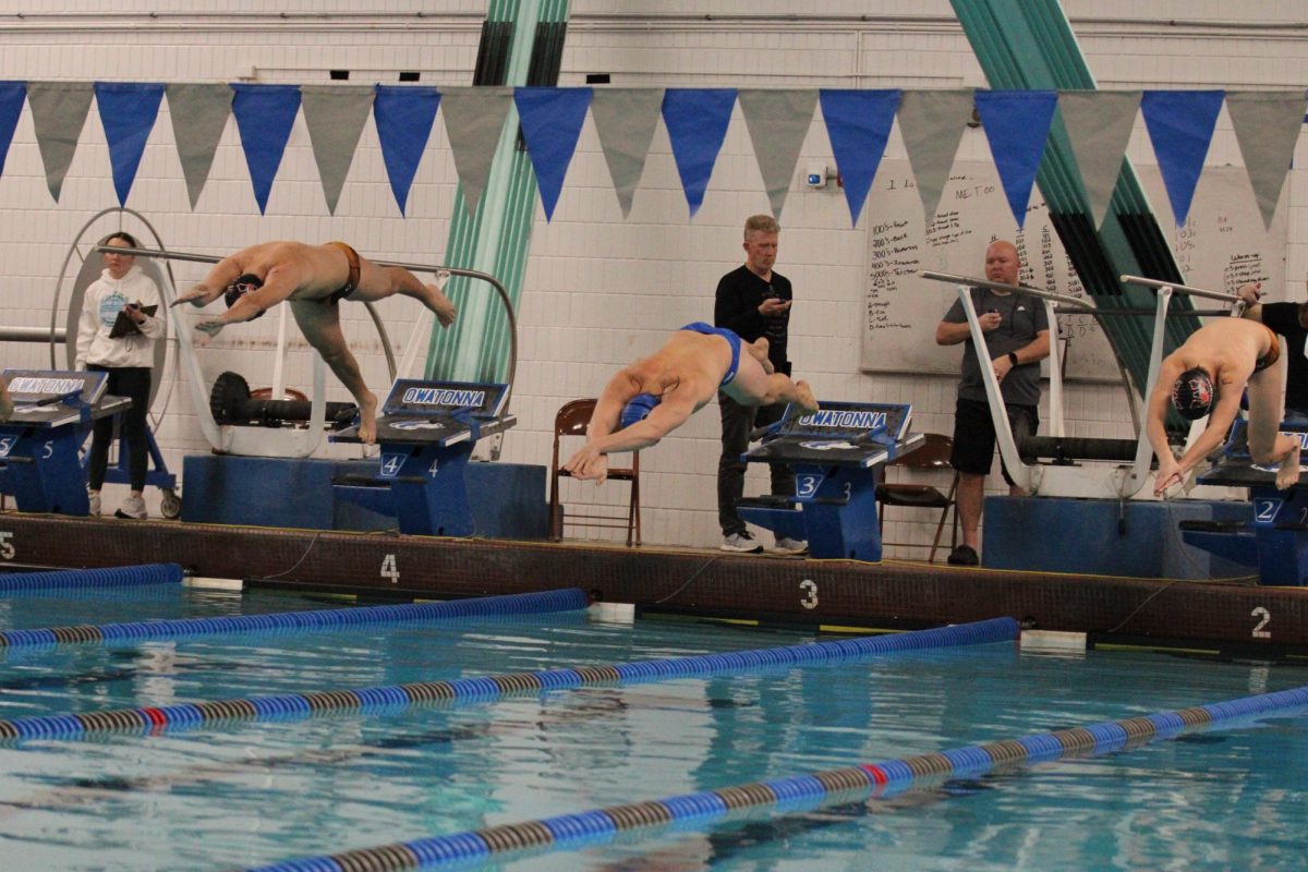 Senior, Carter Quam Diving into the pool at the start of his race. 