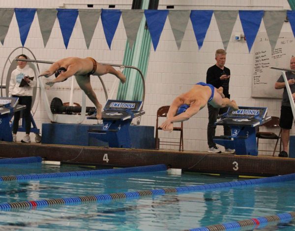 Senior Carter Quam diving into the pool to start his race.