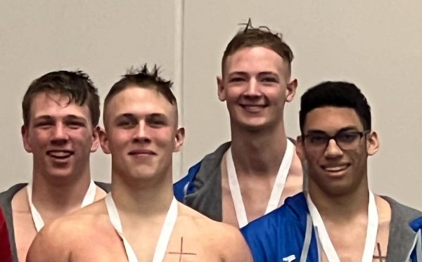 The 400 freestyle relay team smiling after qualifying for the Minnesota State Swimming and Diving tournament. 