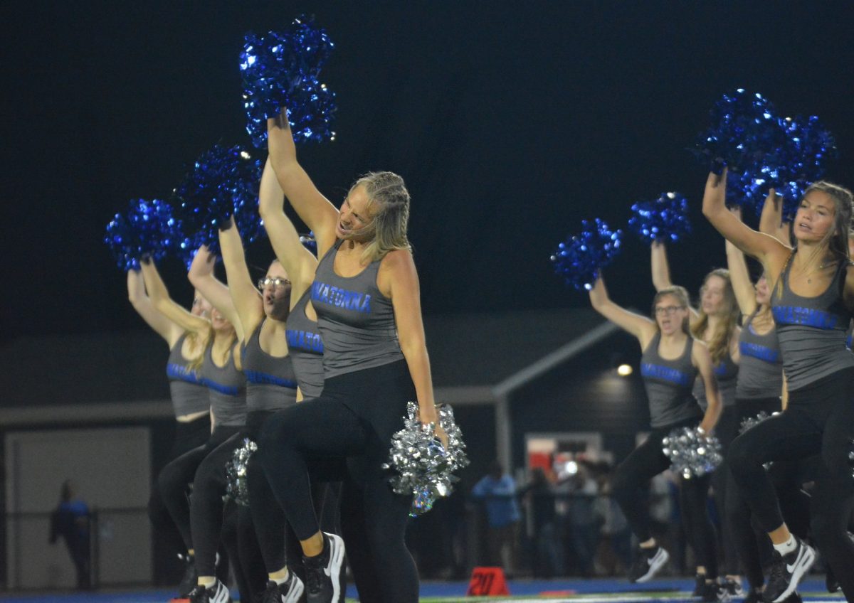 Owatonna Dance Team dancers strike a pose at the homecoming football game.