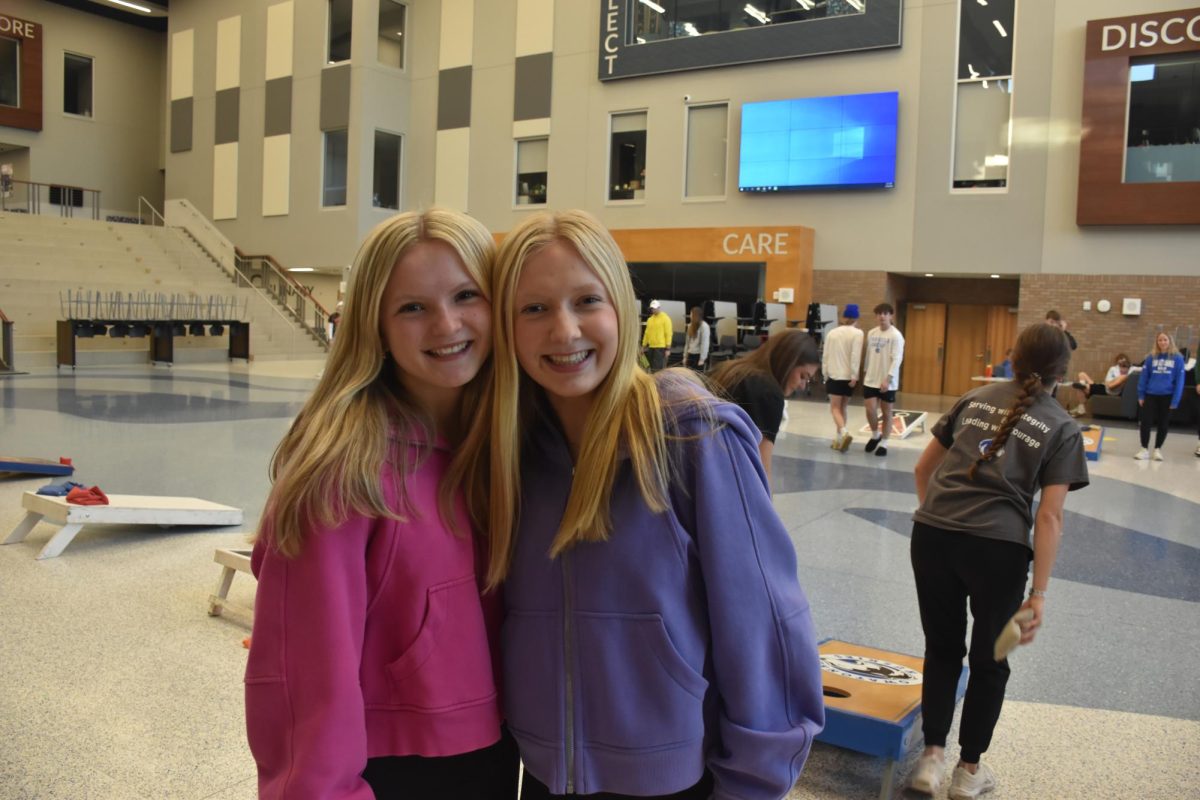 Emily Mcmasters and Taylor Schewe smile for a picture at the NHS backyard BBQ tournament.