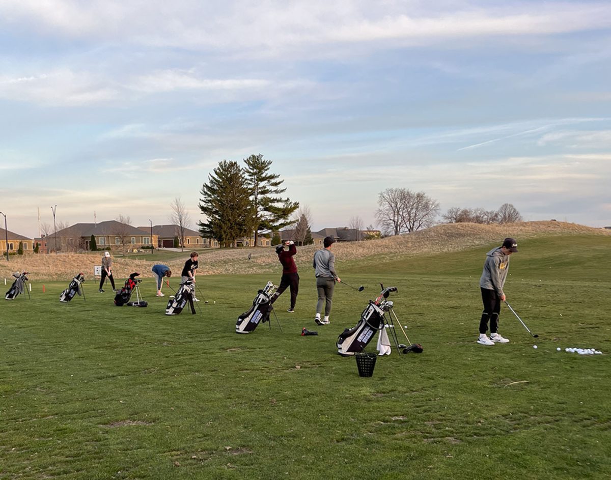 Boys+Golf+team+warming+up+at+the+driving+range+before+a+meet.