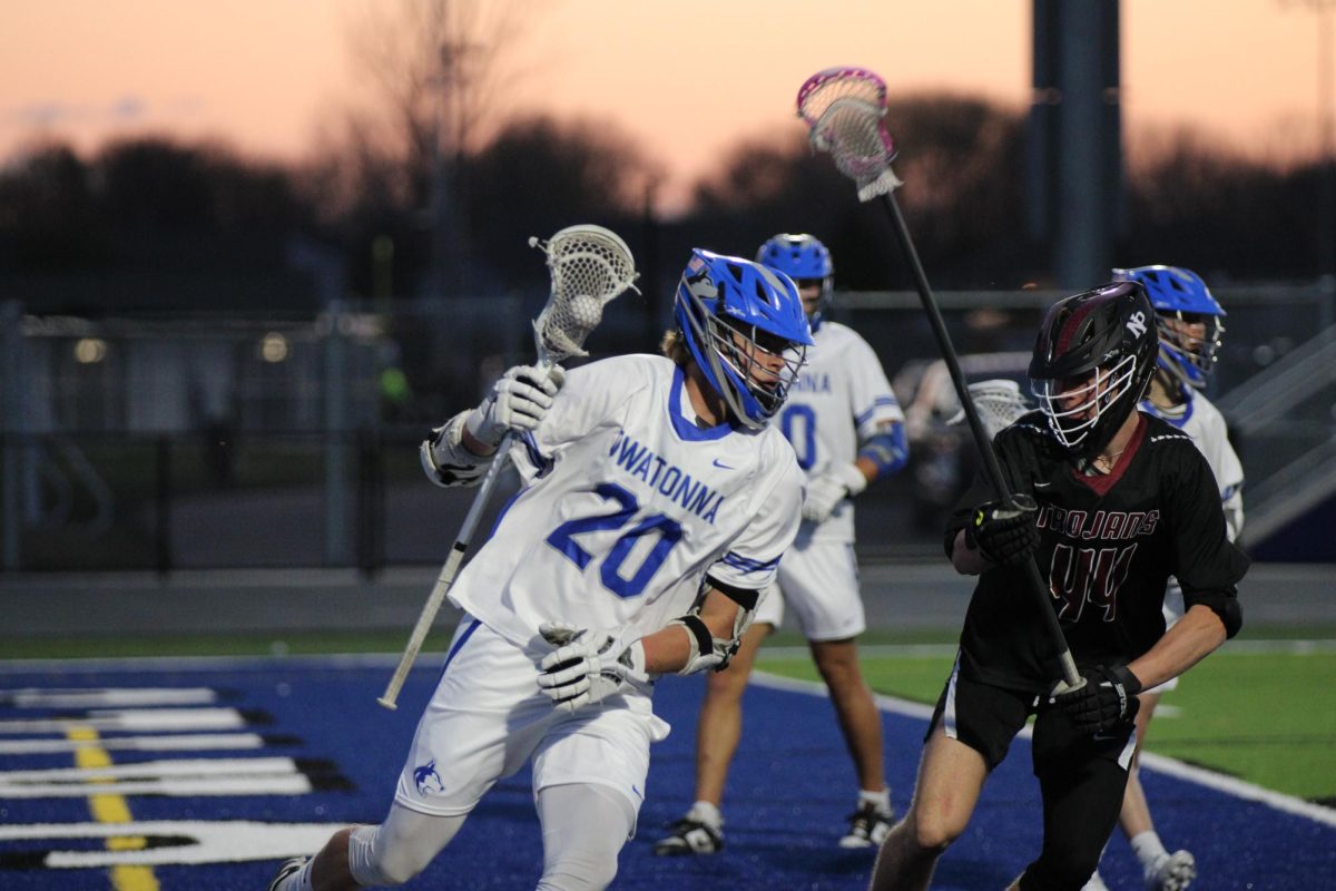 Senior captain Jack Strom cradles the ball while looking to score. 