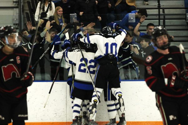 The Huskies celebrate with the student section after a big goal.