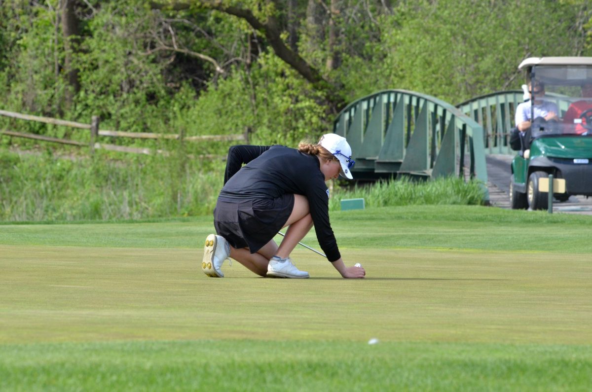 Paige Thompson lines up her ball for her putt. 