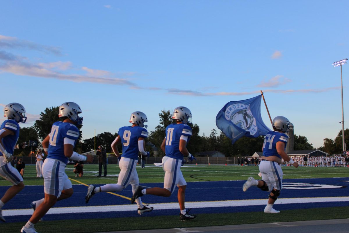 OHS Football charges onto the field. 