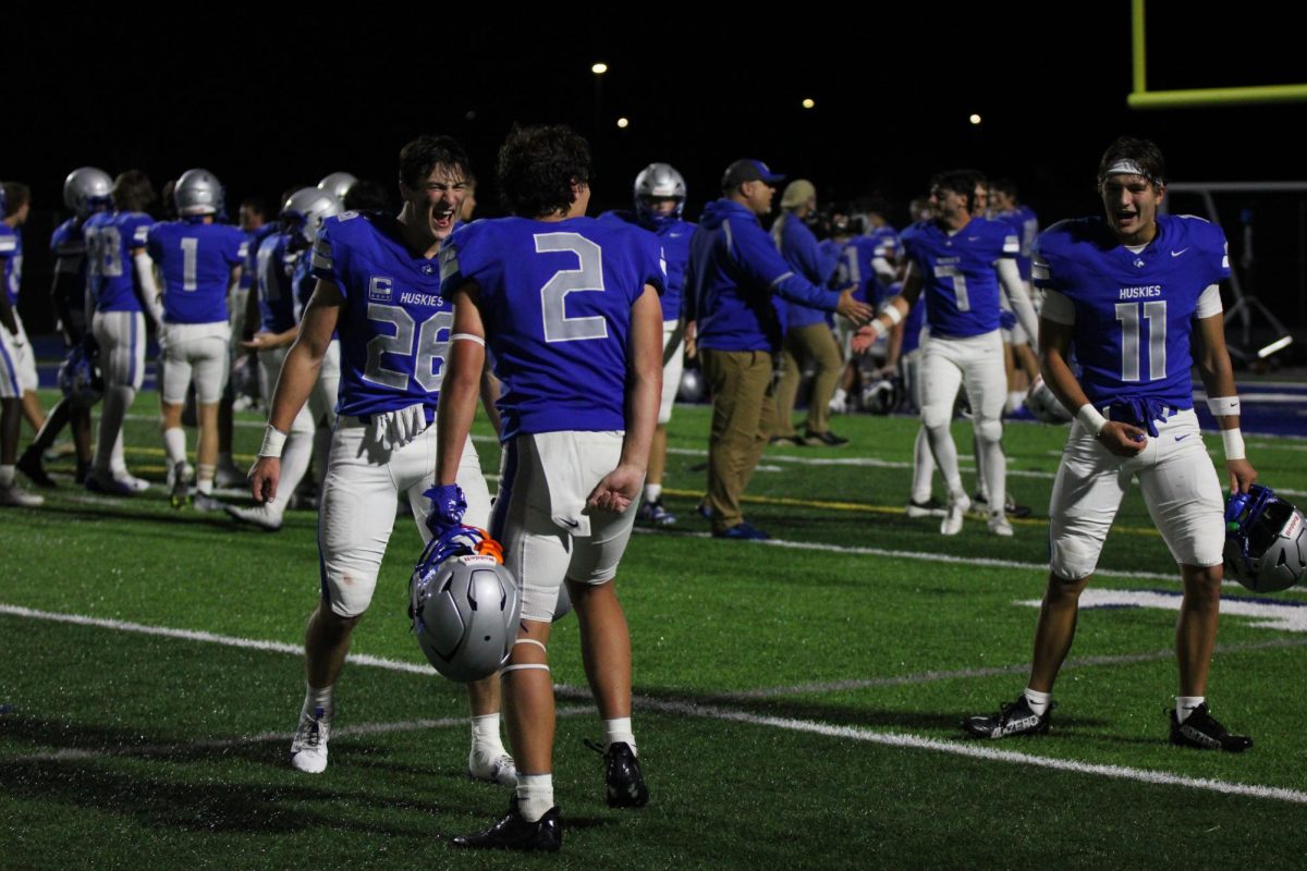 Seniors Blake Davison, Seth Johnson and Luke Webber celebrate after their 21-7 win against the Chanhassen Storm.