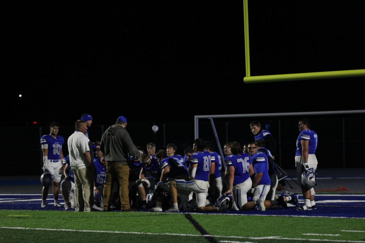 Concluding the game, the OHS Football team huddled up.  