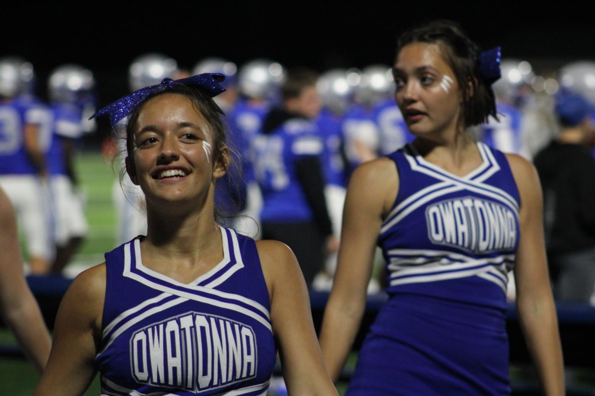 Junior Georgia Schrom and senior Sofia Escobedo focus on the cheer. 