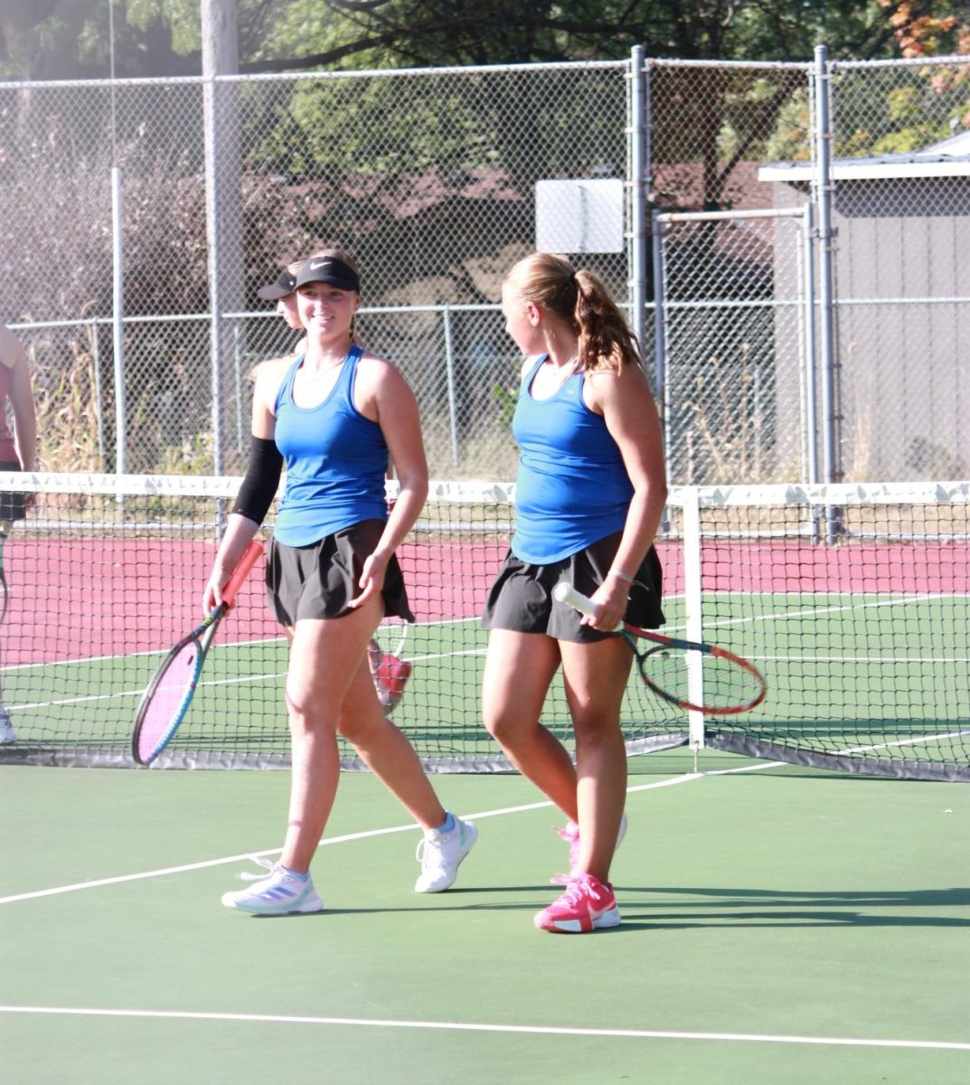 Junior Harper Shives and freshman Greta Veldman celebrate their set point. 