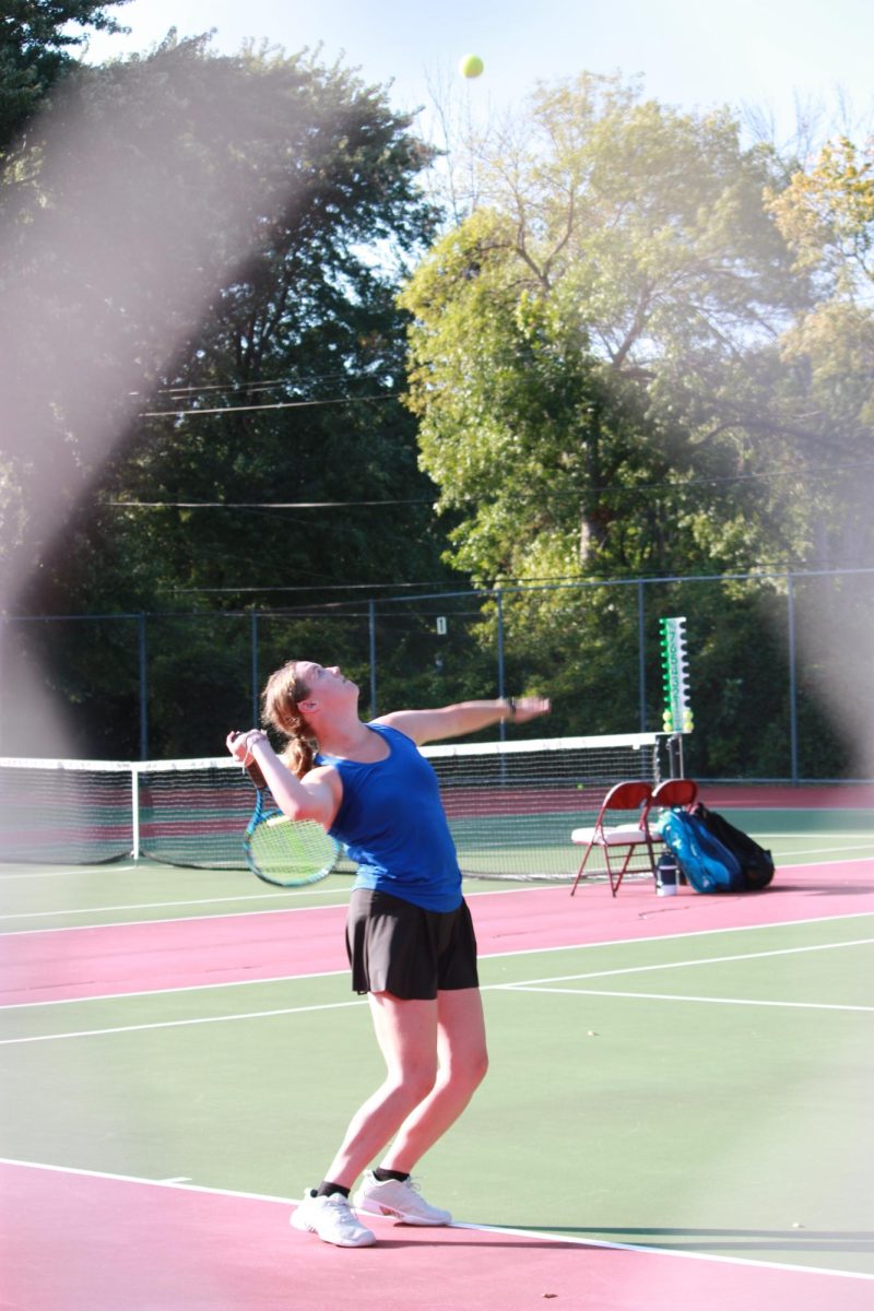 Senior Ellery Blacker as she servers the ball.