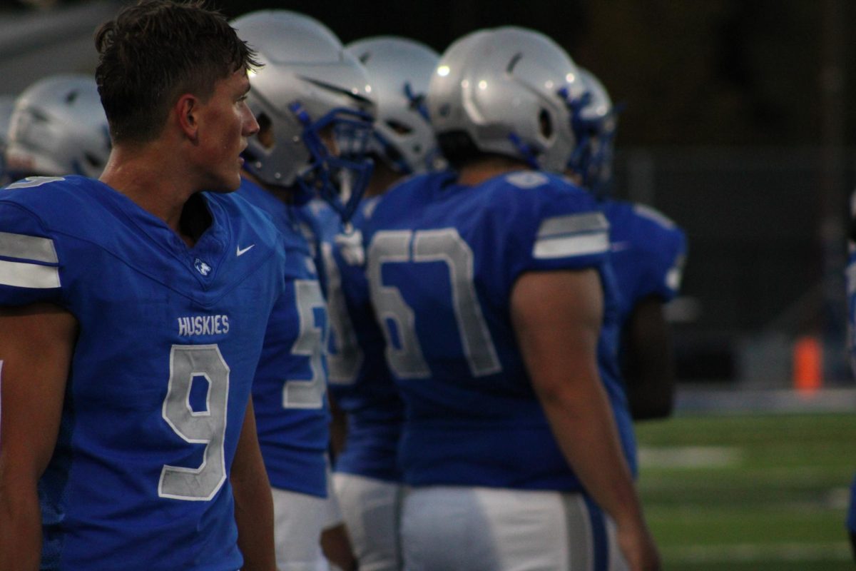 Senior Jamie Lisowski looks onto the field during the play. 