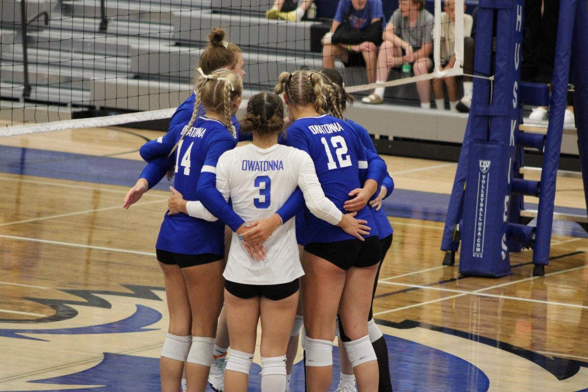 Juniors Libby Jensen and Kendra Bogen celebrate with senior Halle Theis after a play. 