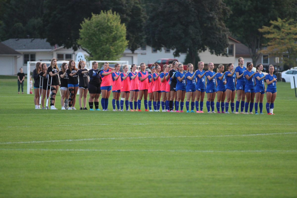 Owatonna Girls Soccer team lines up for the National Anthem.