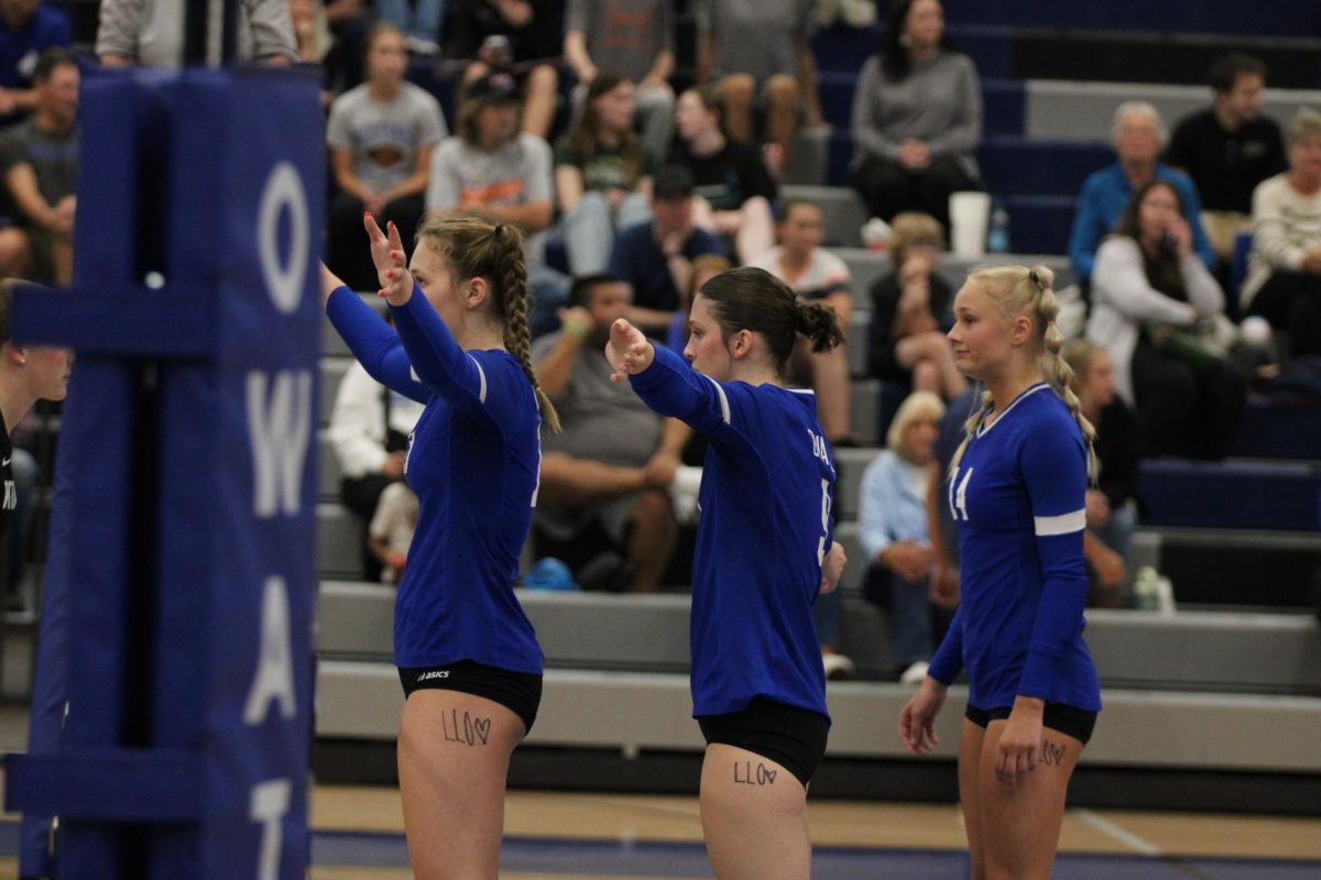 Junior Danielle Roush (F), Senior Brea Belting (M) and Junior Libby Jensen (E) ready for serve receive.