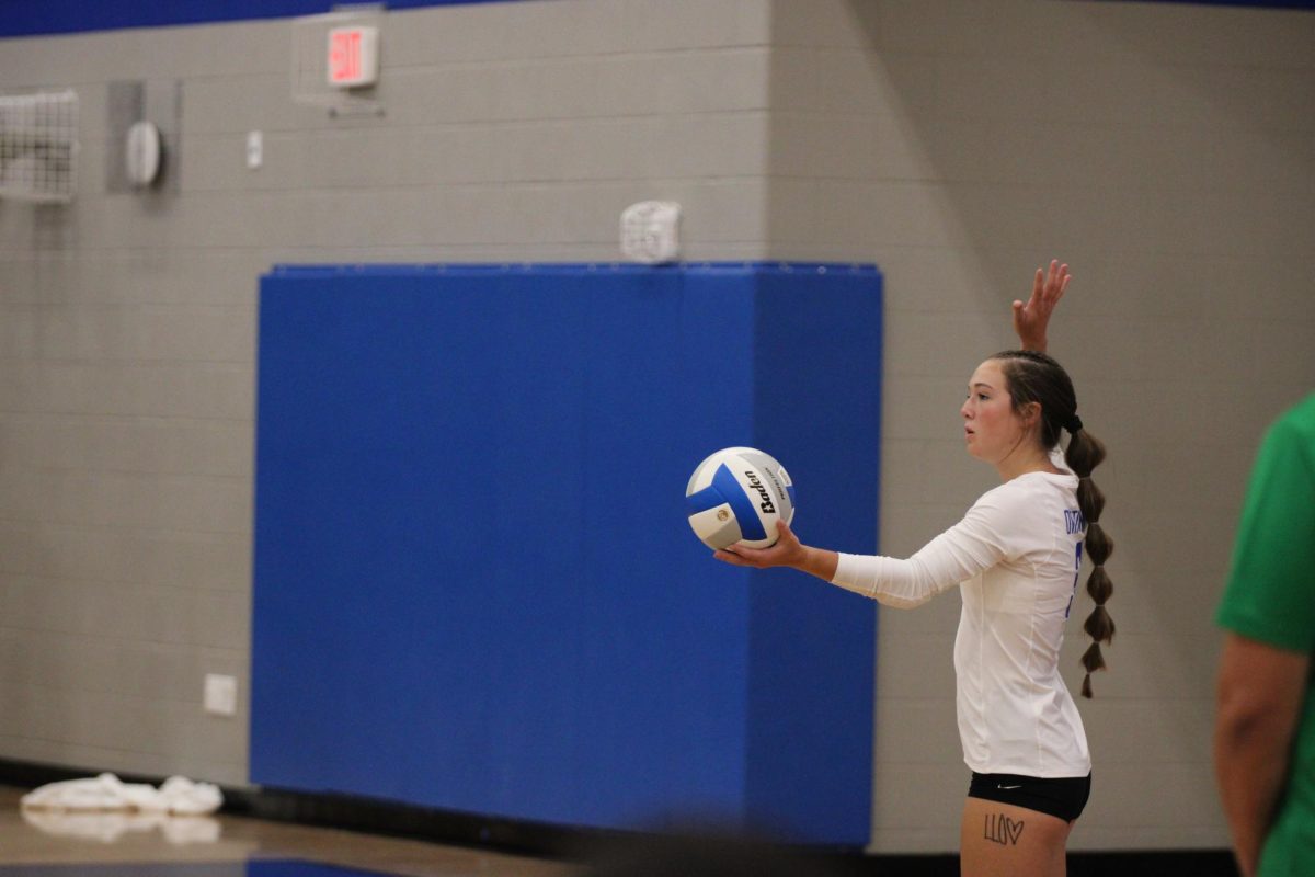 Senior captain Halle Theis gets ready to serve the ball.