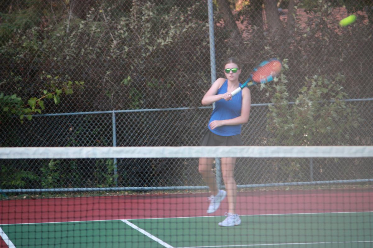 Senior Hannah Nelson returns the ball to her opponent.